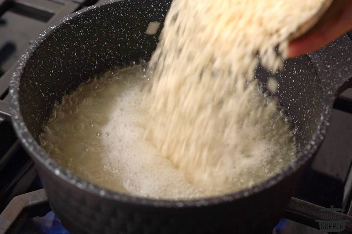 rice being added to the boiling water