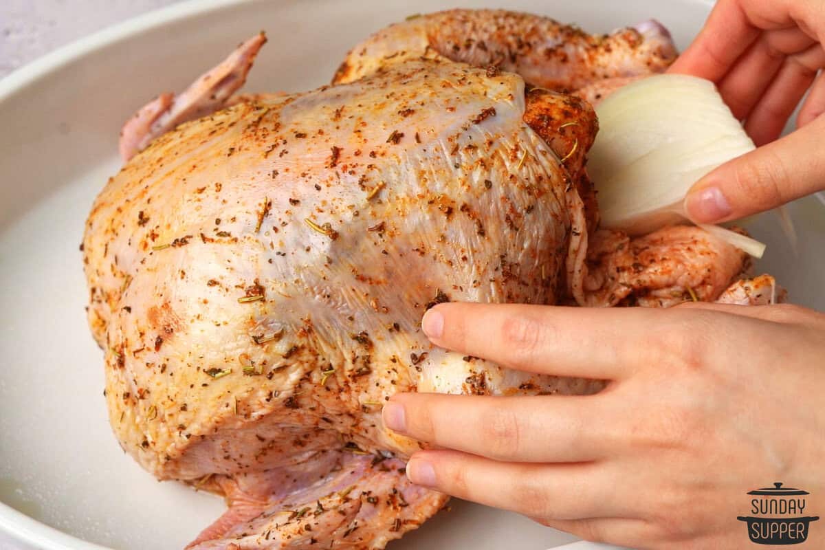 stuffing being placed in the chicken