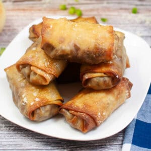 a plate of toasty cheesesteak egg rolls