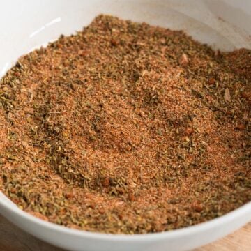 a closeup of a bowl filled with mixed creole seasoning