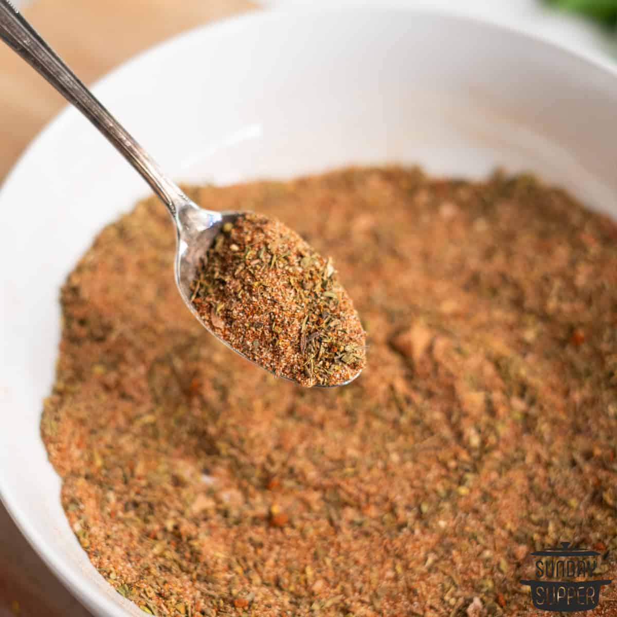 a spoonful of creole seasoning over a bowl