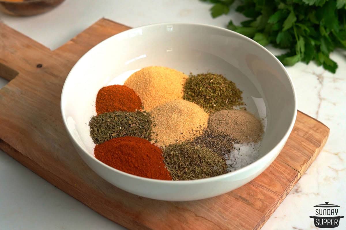 a bowl with the ingredients for creole seasoning added