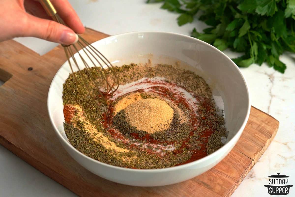 the seasoning being mixed with a whisk