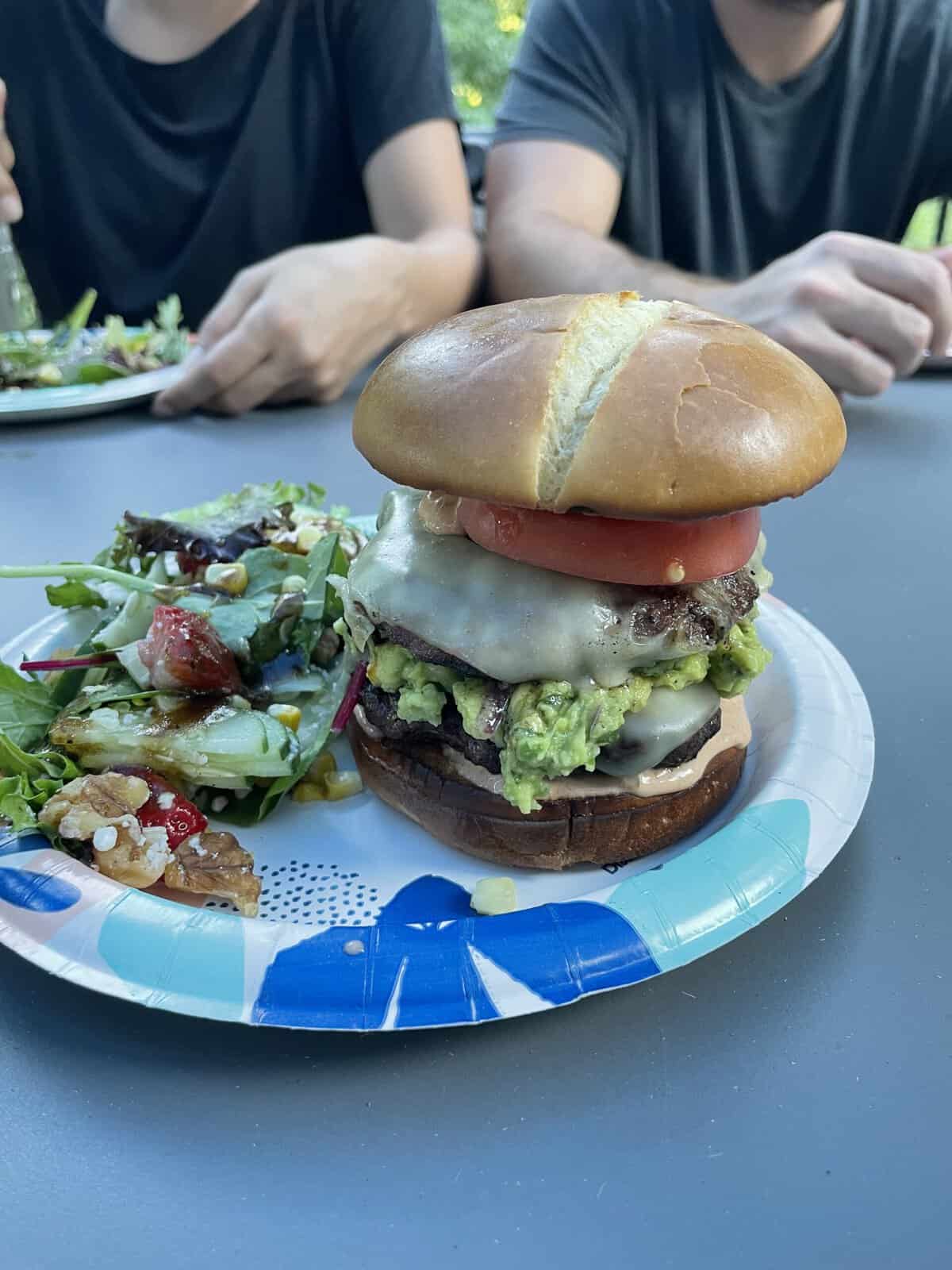 A juicy gourmet burger with guacamole on a plate