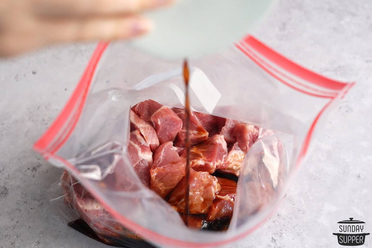 the pork and marinade being combined in a bag