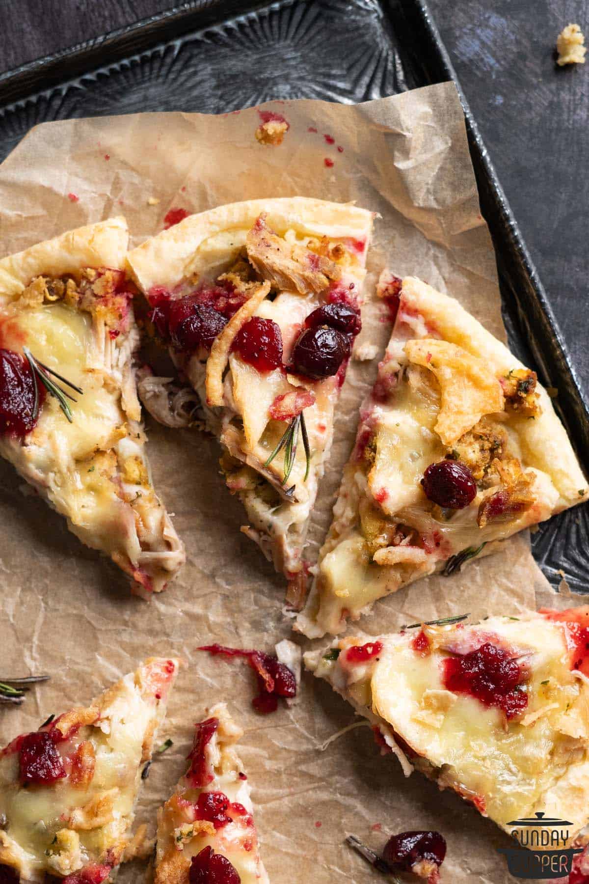 slices of thanksgiving pizza on parchment paper