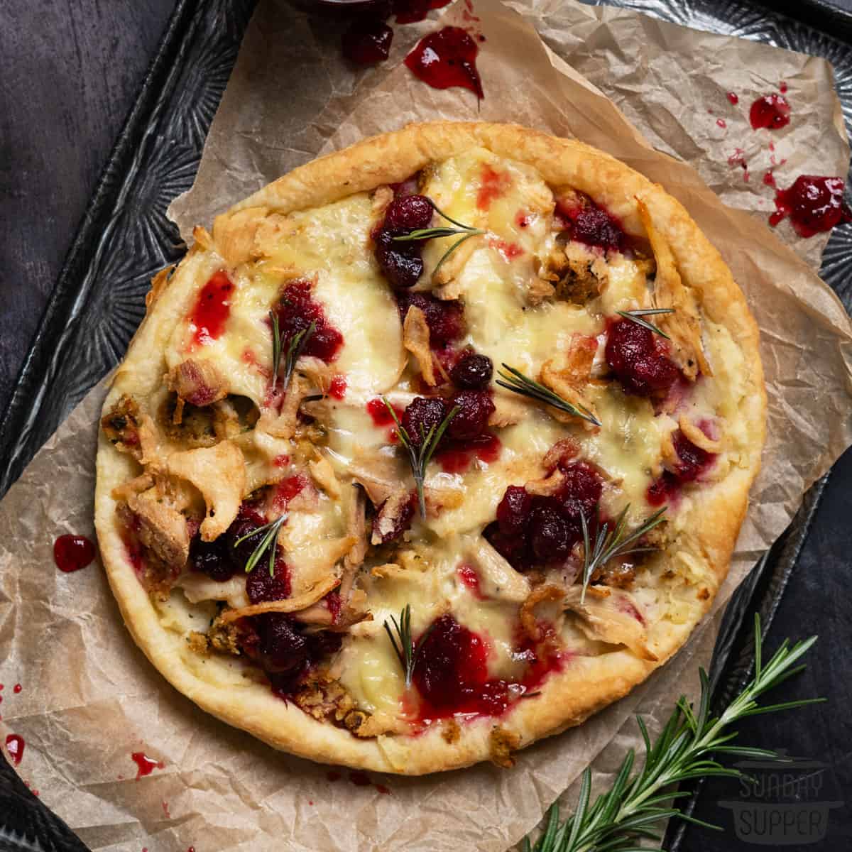 a baked leftovers thankgiving pizza on a baking tray