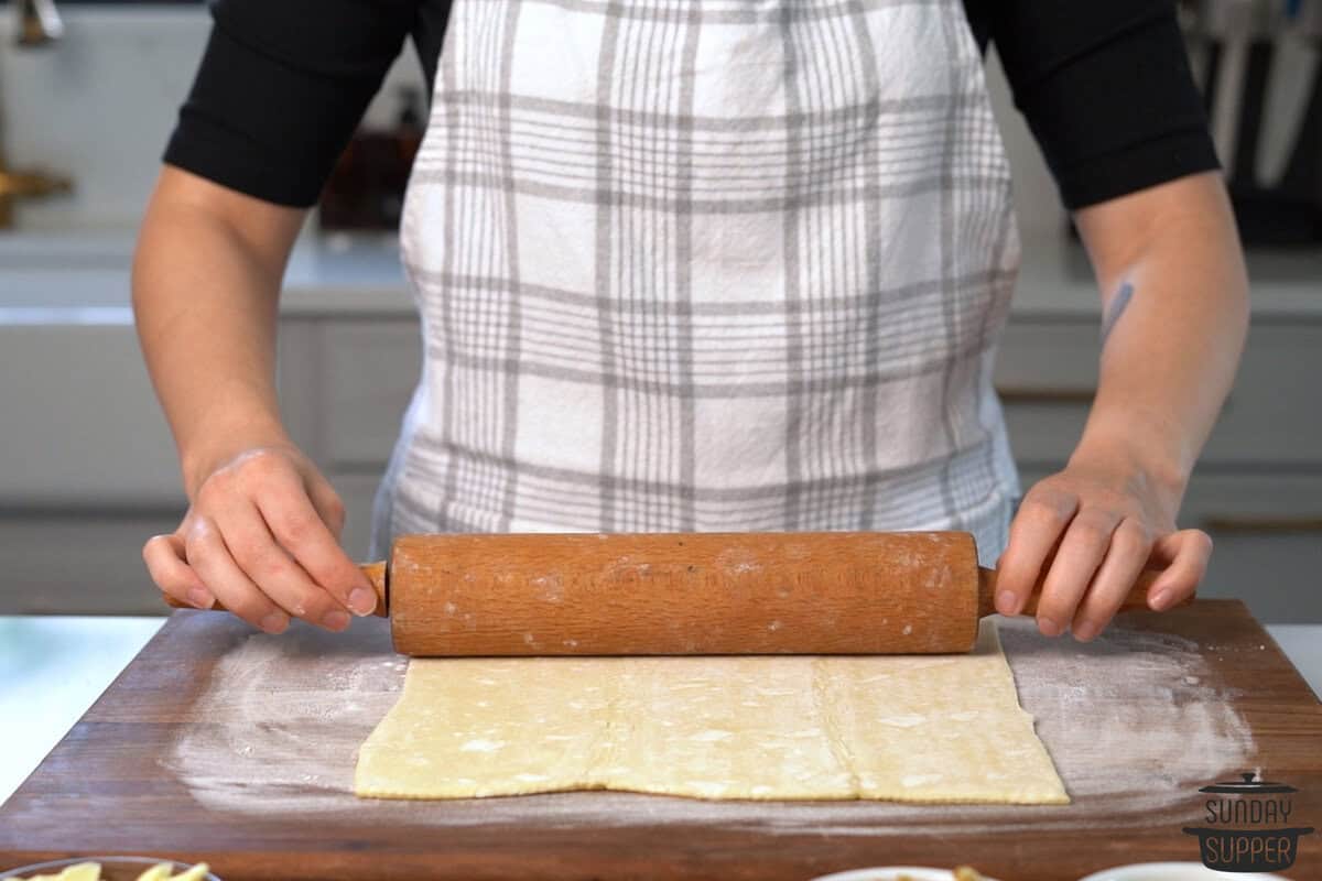 puff pastry being rolled out on a floured surface