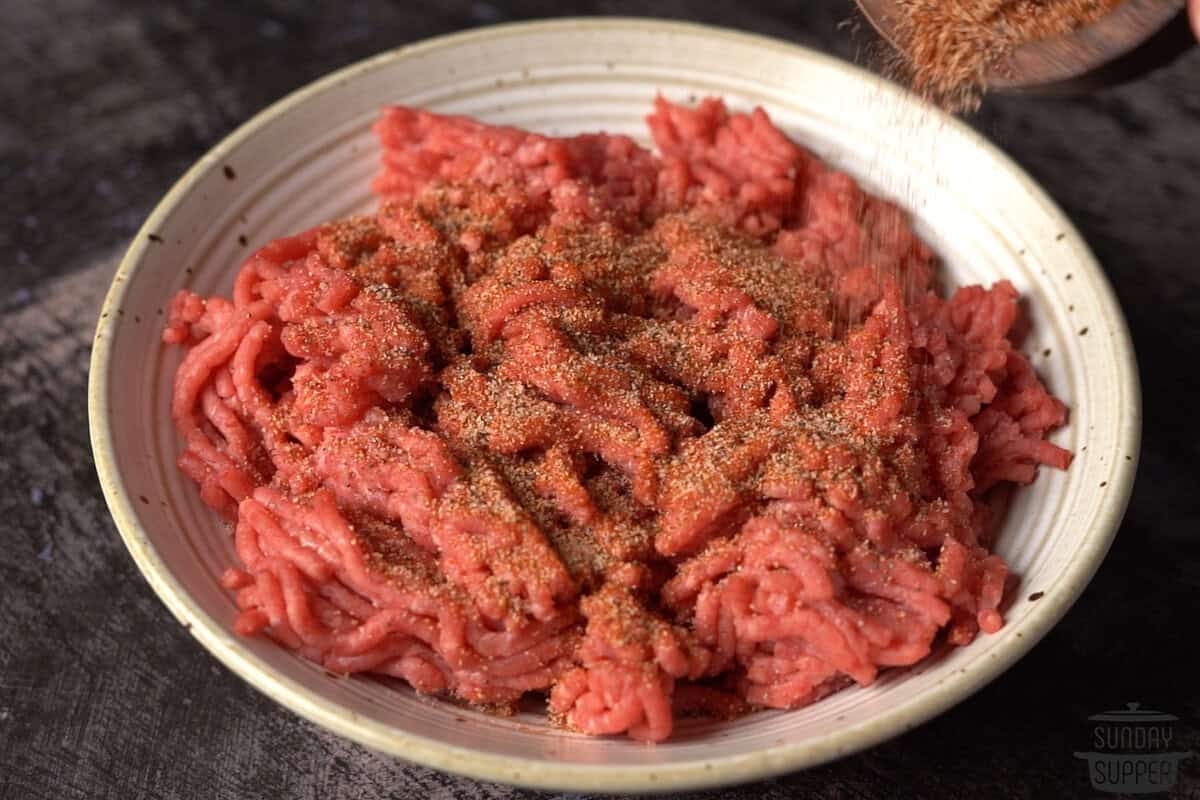 mixing ground beef in a bowl