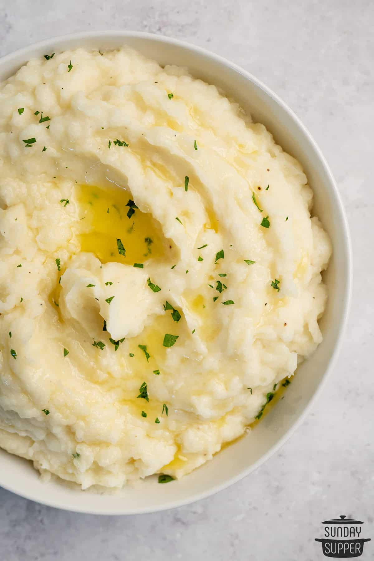 creamy mashed potatoes in a white bowl