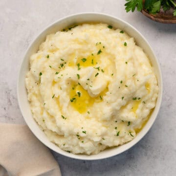 close up of creamy mashed potatoes in a white bowl