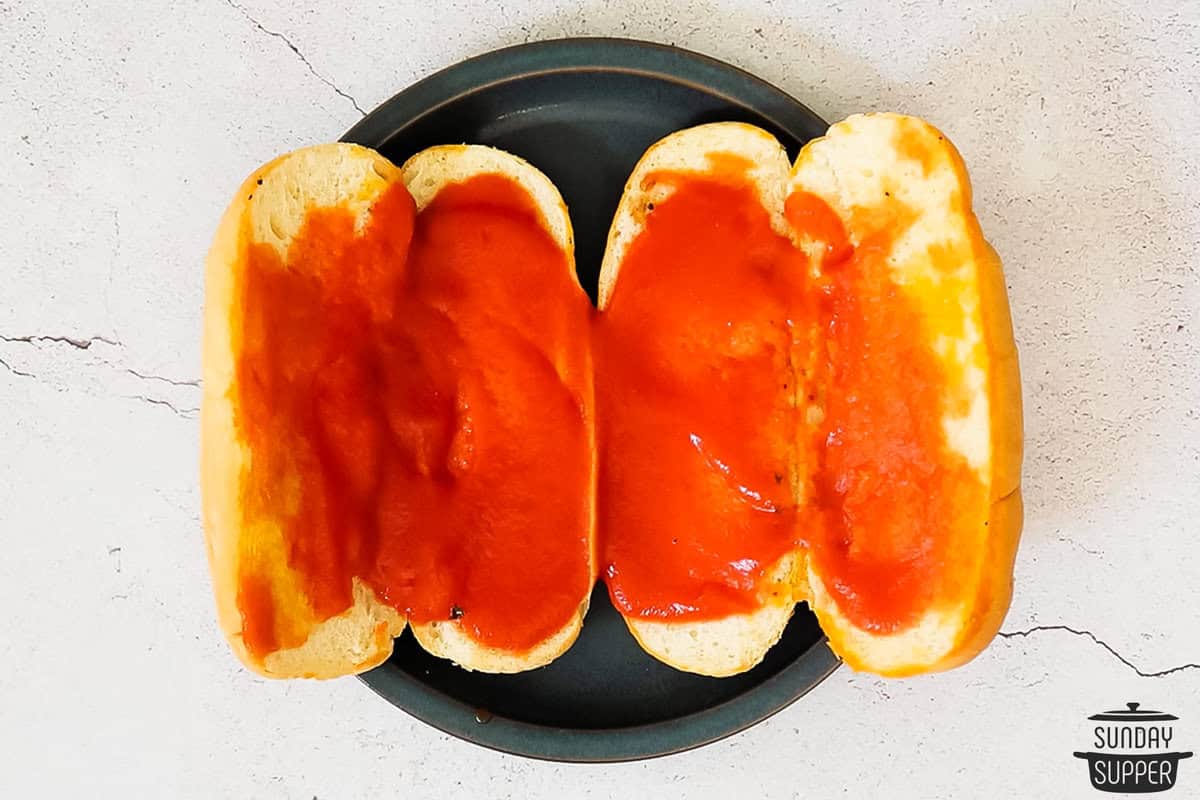 tomato sauce spread on the rolls