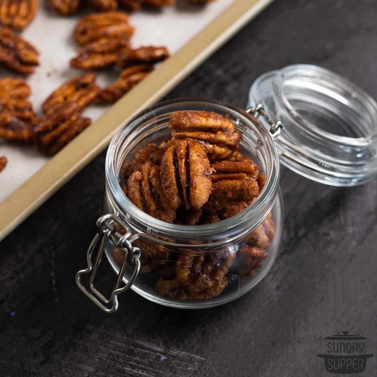 a small glass jar filled with candied pecans