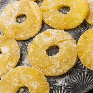 candied pineapple rings on a serving tray