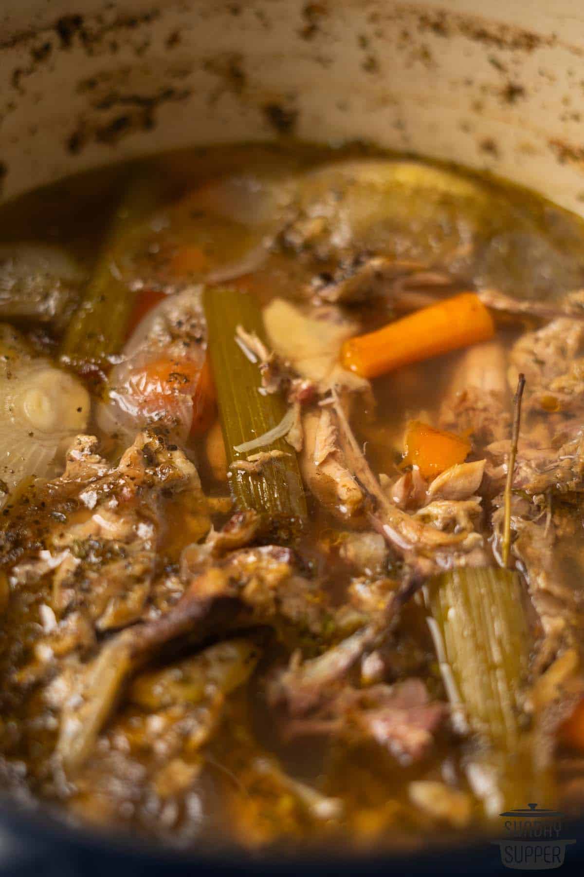 chicken bone broth in a pot before straining