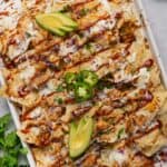 a closeup of a baking tray with loaded chicken nachos