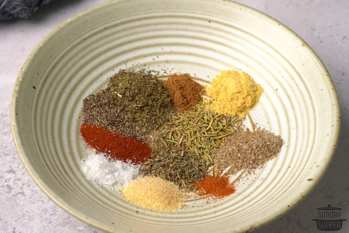 chicken seasoning ingredients added to a bowl