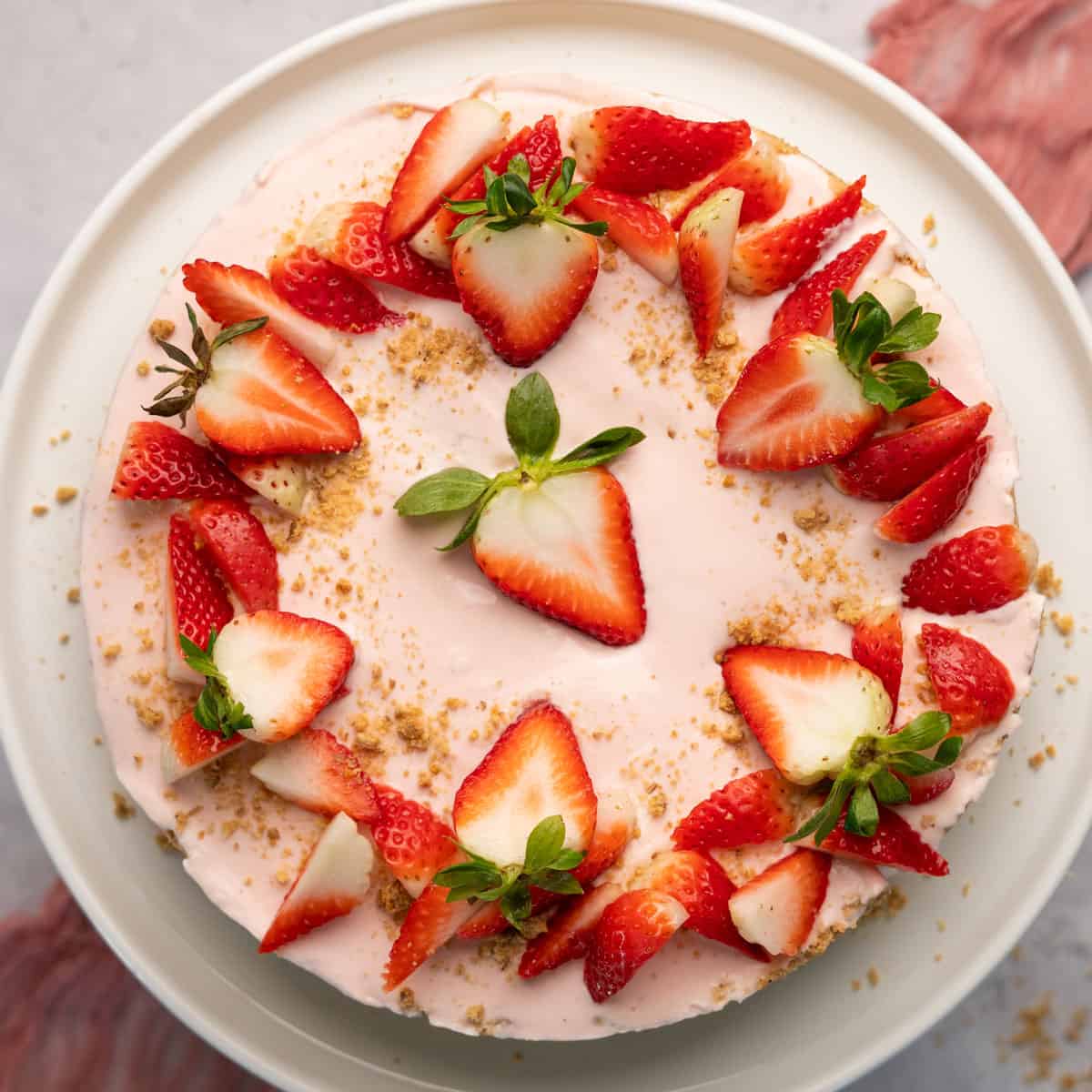 a top down view of a strawberry cheesecake with fresh strawberries