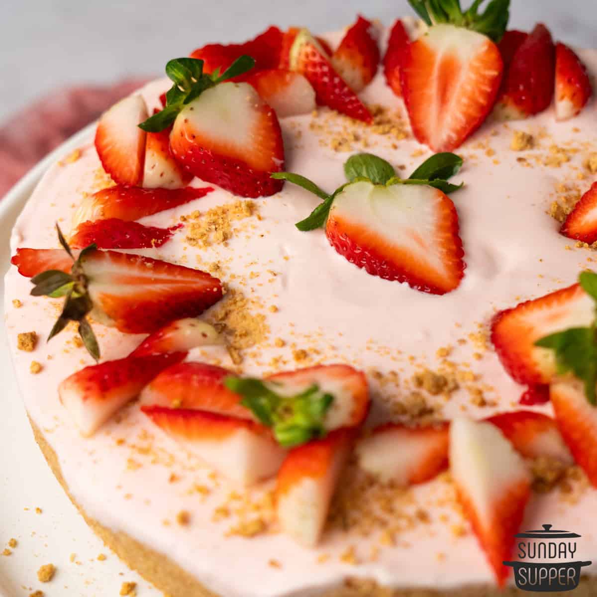 a close up of a no bake cheesecake with strawberries