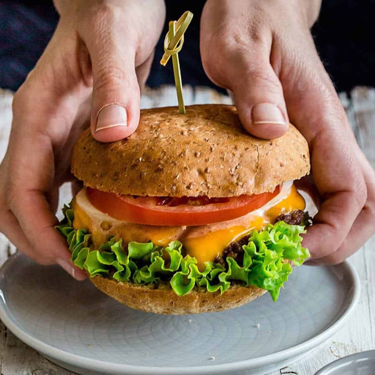 hands holding a completed smash burger