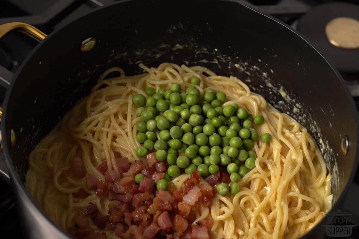 adding peas and pancetta to the pot
