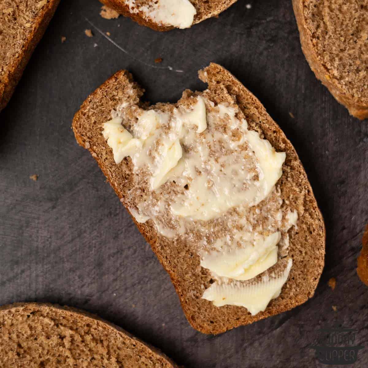 close up of a slice of sprouted bread with butter