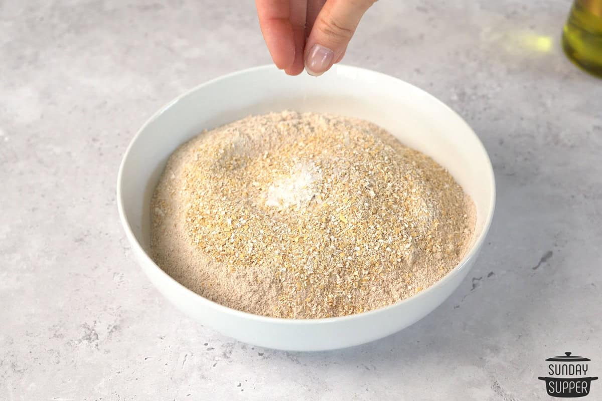 adding dry ingredients into a bowl