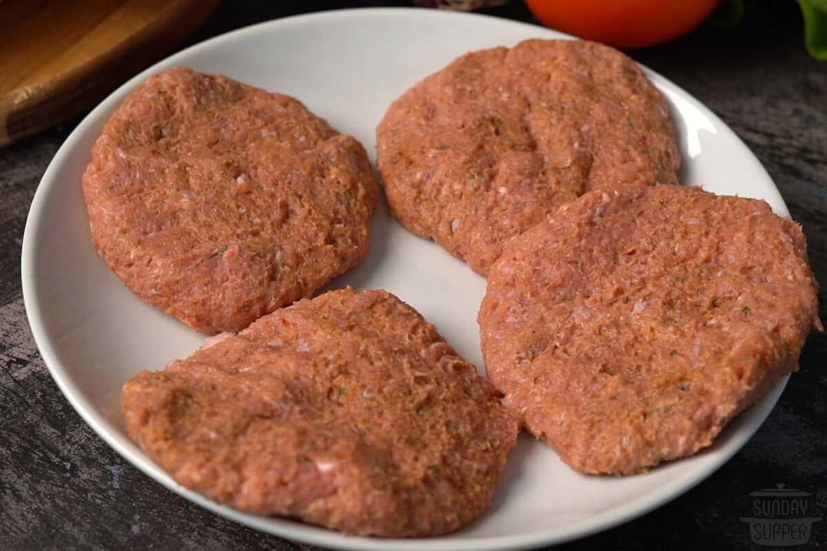 three assembled turkey burger patties on a plate