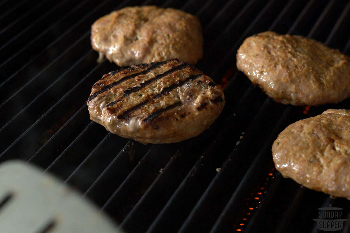 the patties added to the grill to cook