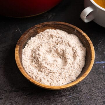 a wooden bowl of seasonings