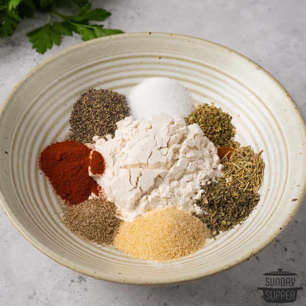 all the ingredients for beef stew seasonings in separate piles in a bowl