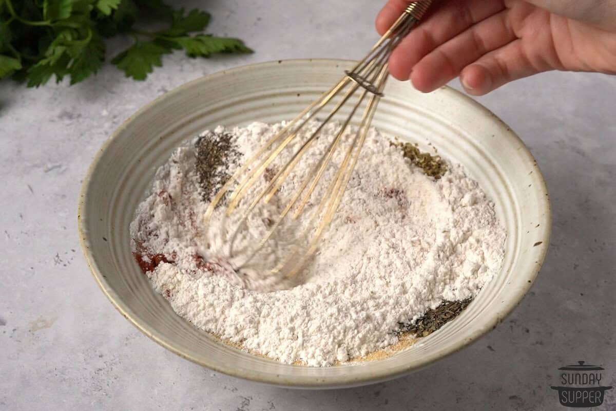 beef stew seasoning being whisked in a bowl