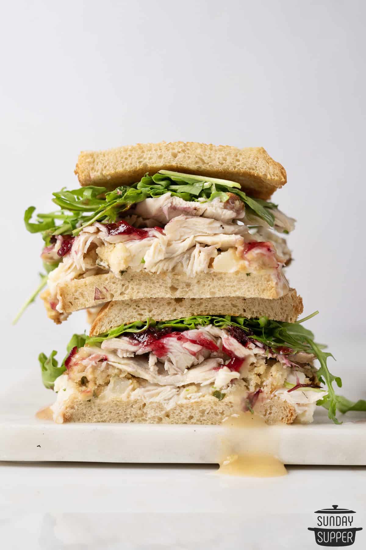 two halves of a thanksgiving sandwich stacked on top of each other