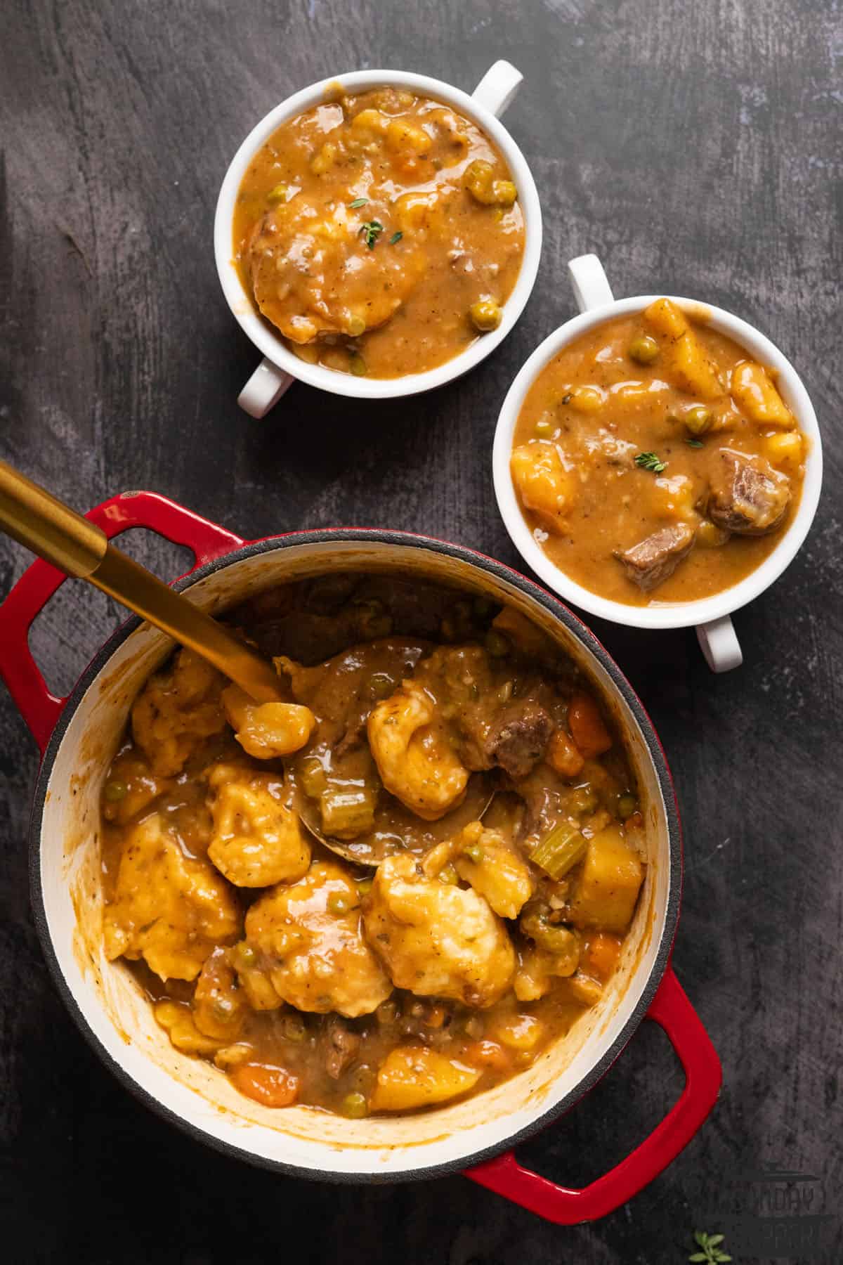 a pot of beef stew and two bowls of stew