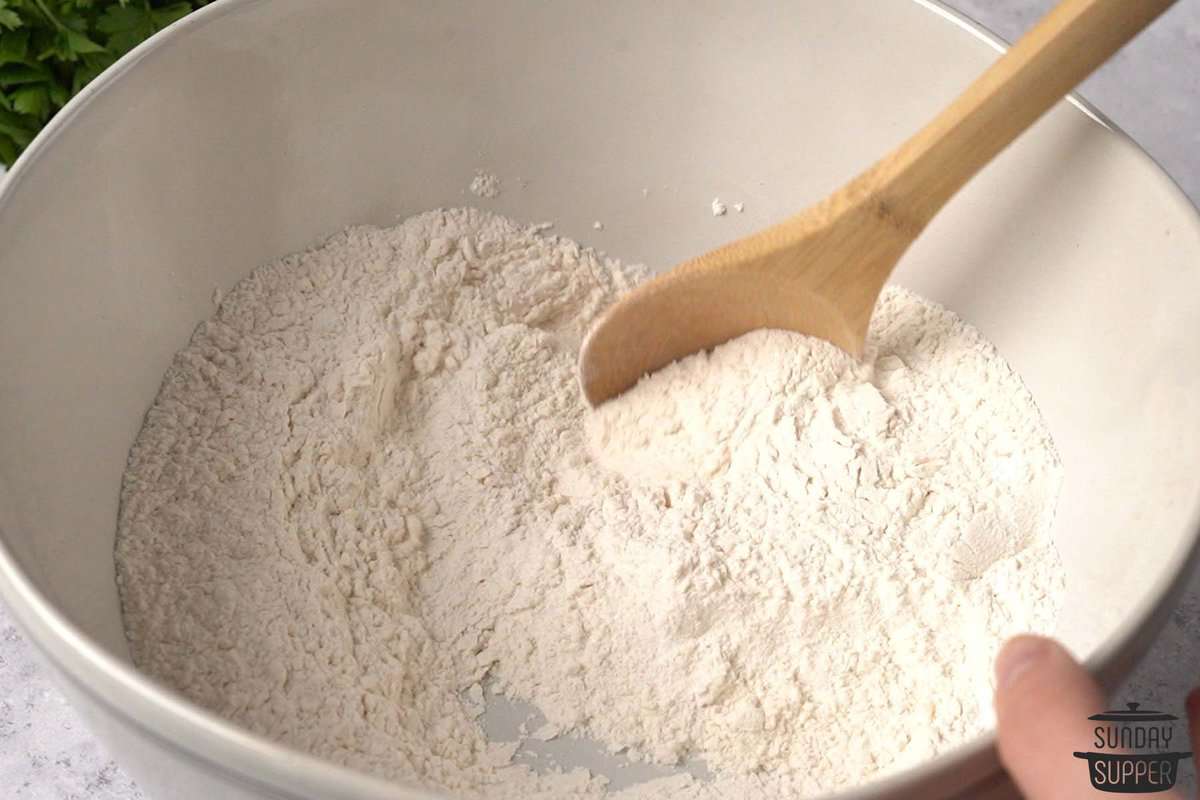 the dry ingredients being stirred in a bowl