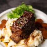 a short rib on a pile of mashed potatoes