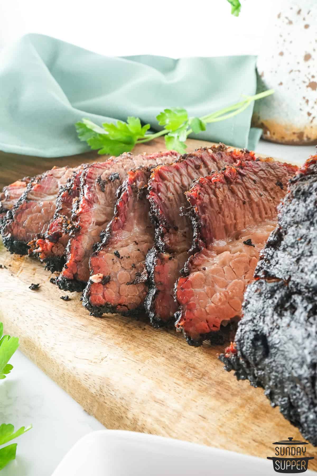 smoked brisket using brisket rub on serving board