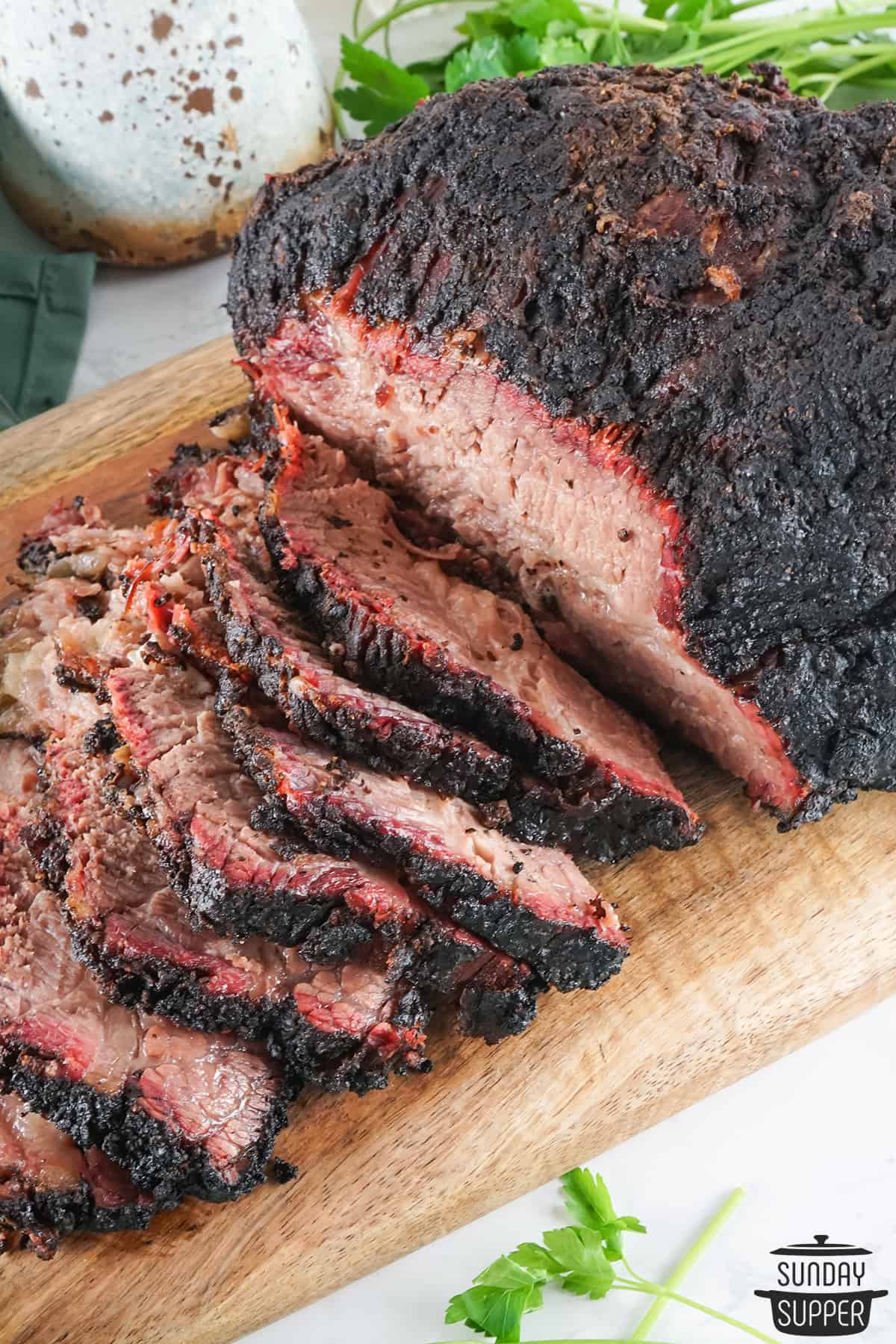 sliced smoked brisket on serving board