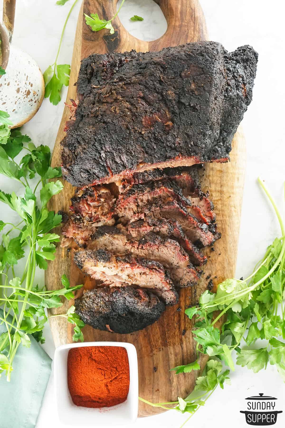 cooked brisket on a serving board