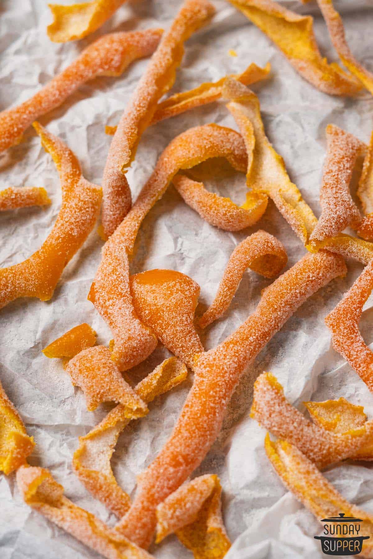 candied orange peels on parchment paper