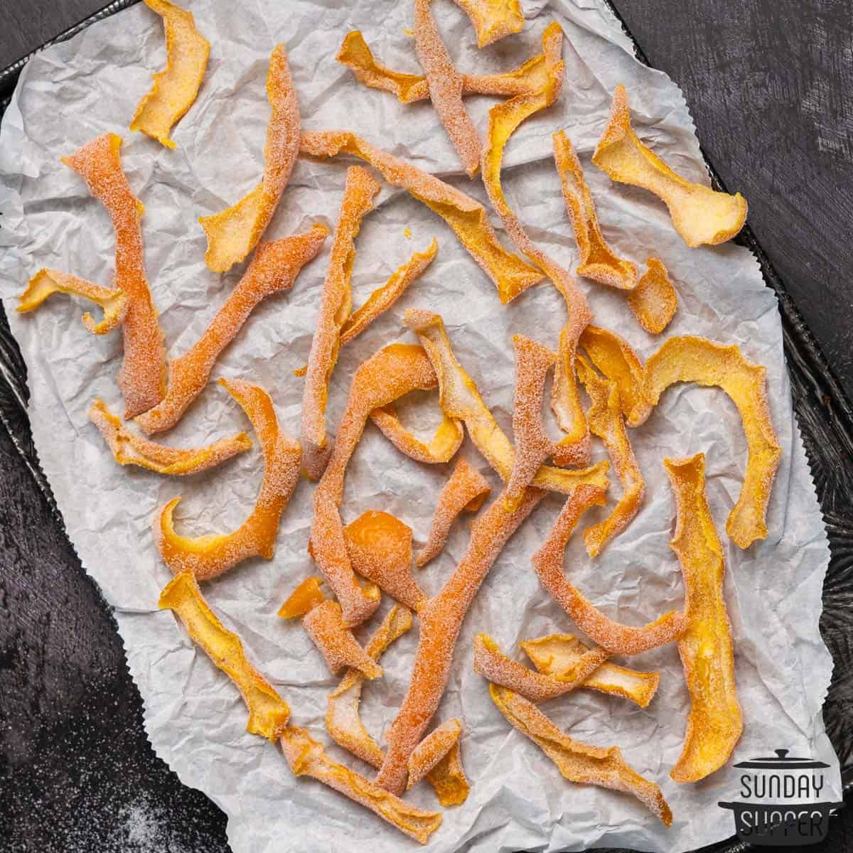 completed candied orange peels on a parchment paper