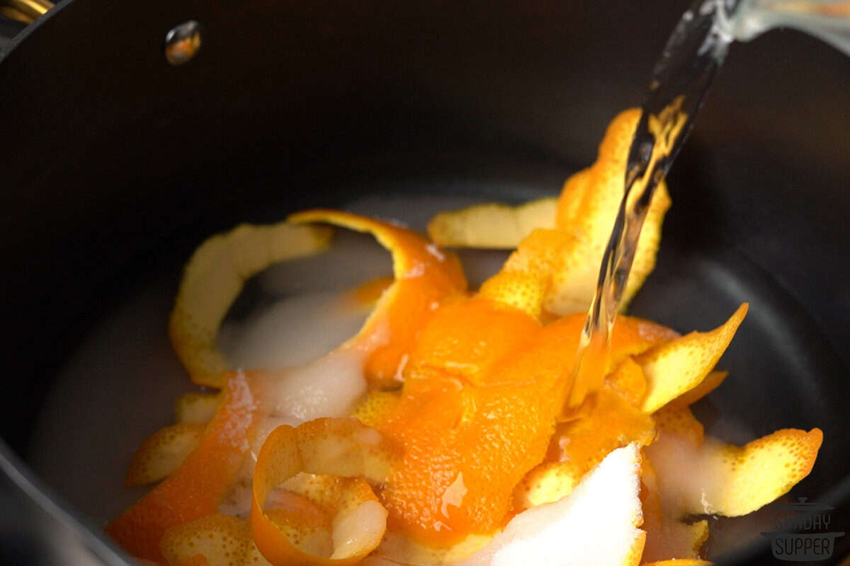 water and sugar being added to the pot