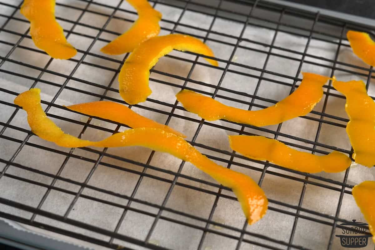 orange peels after being simmered and placed on a drying rack