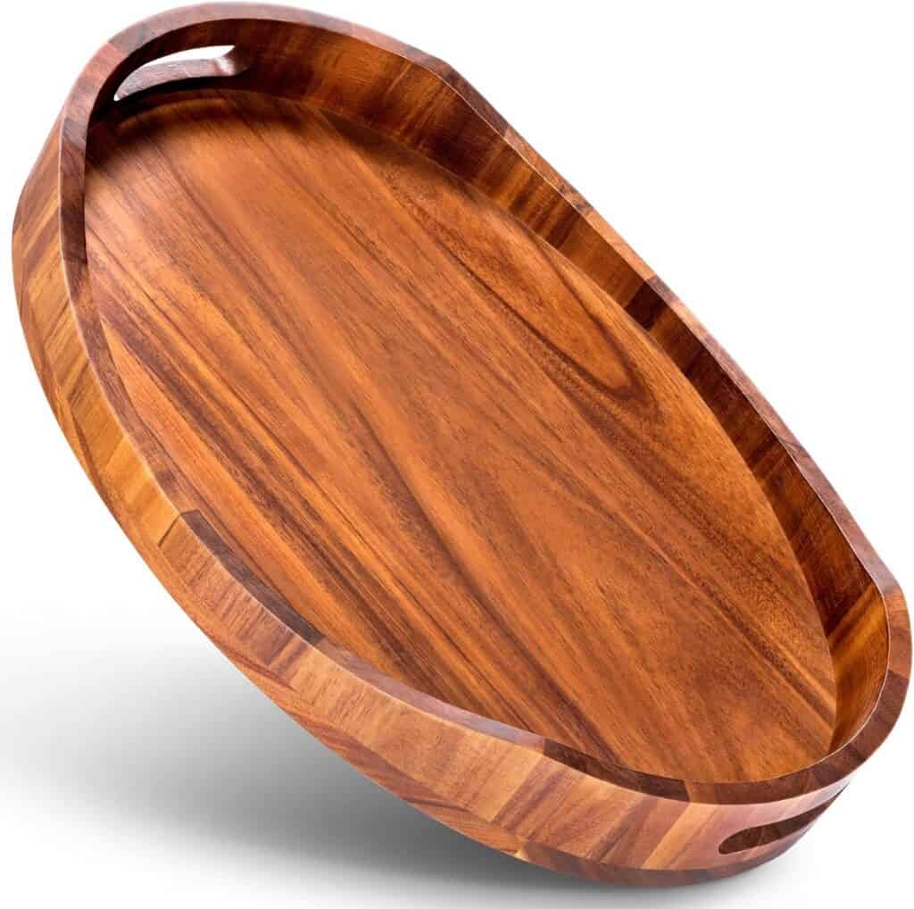 an oval shaped wooden charcuterie board with handles