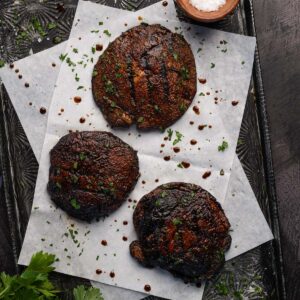 three grilled portobello mushrooms on a tray