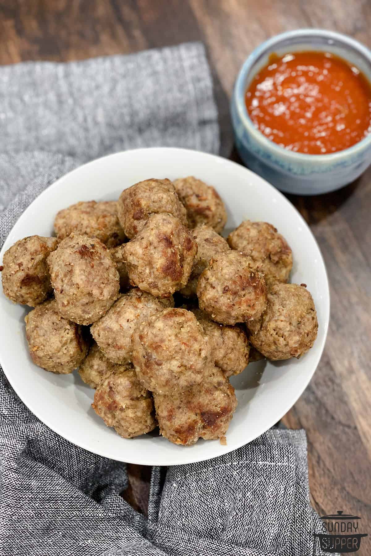 instant pot meatballs on a plate next to sauce in a bowl