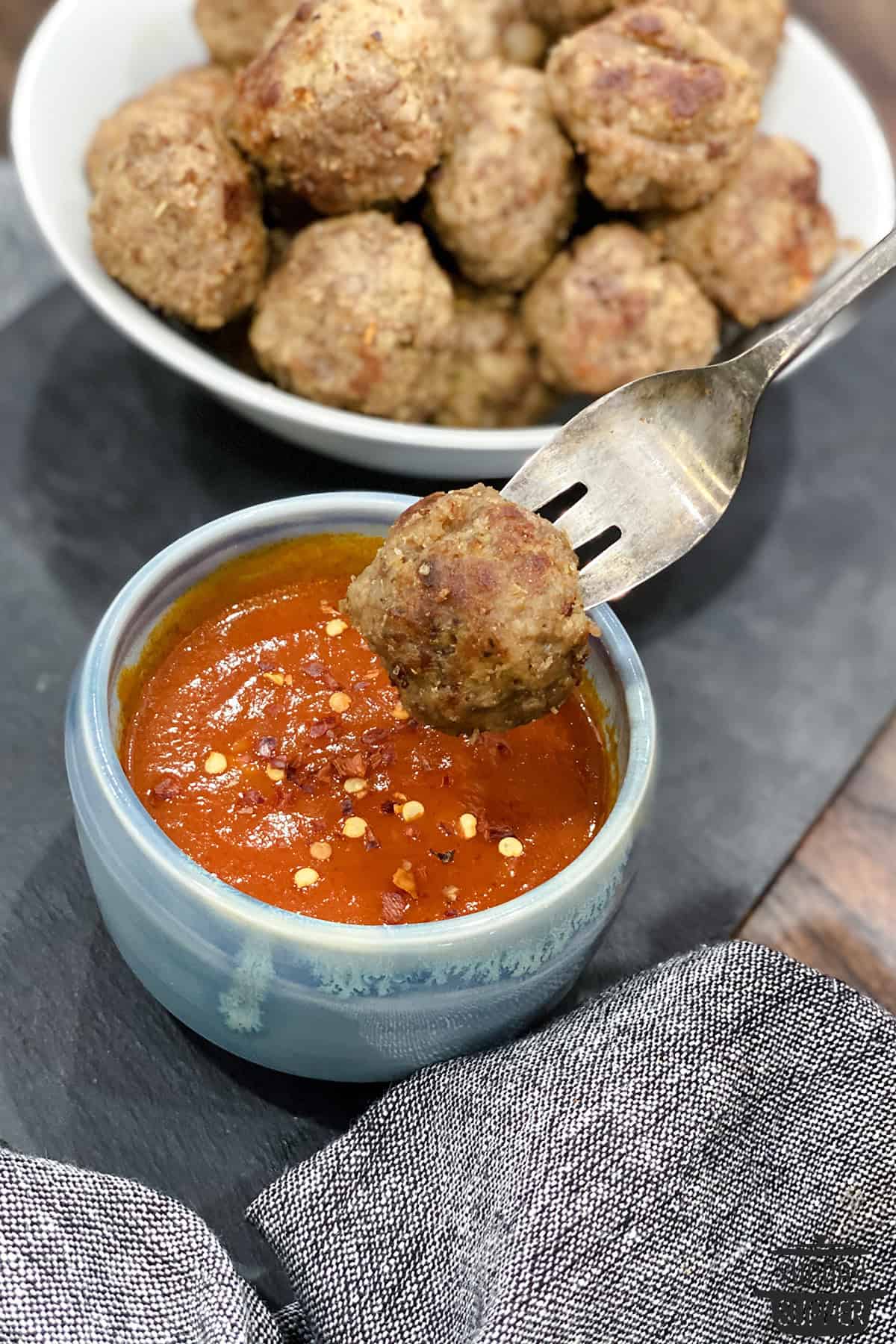 instant pot meatball on a fork dipping into sauce