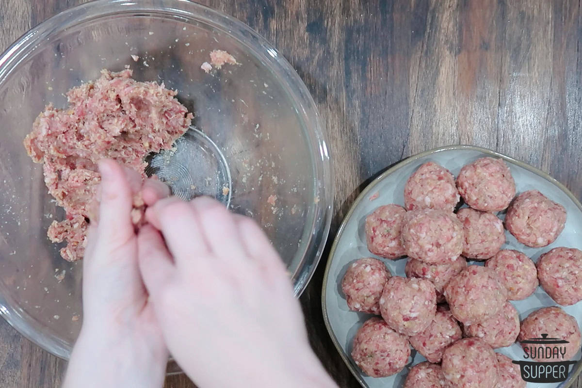 rolling meatballs and placing on plate