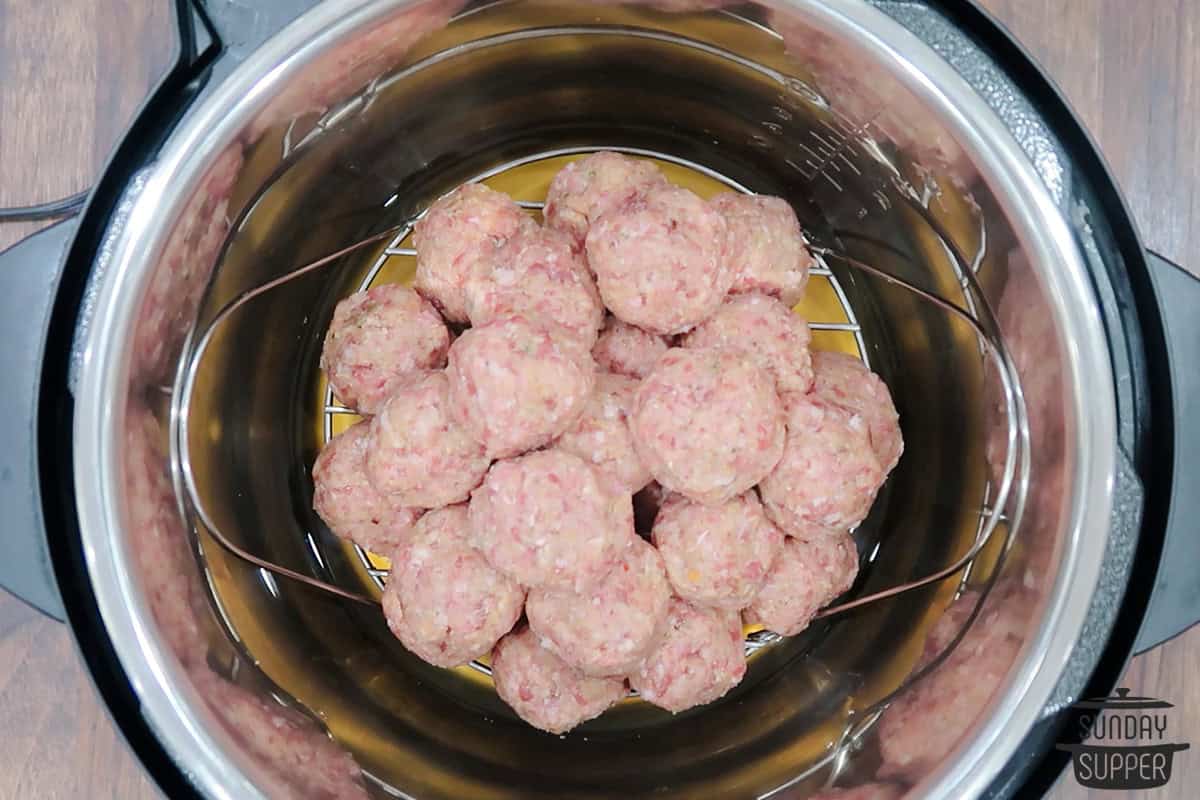 meatballs added to the instant pot on a rack