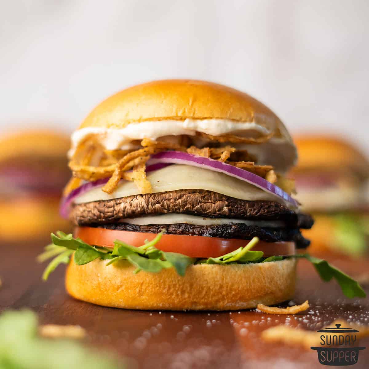 a loaded portobello mushroom burger on a cutting board